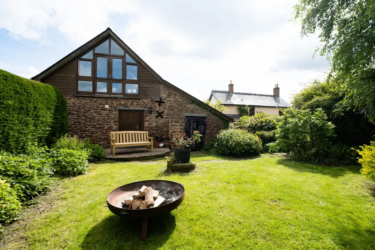The garden looking towards the annexe with the firepit on the lawn