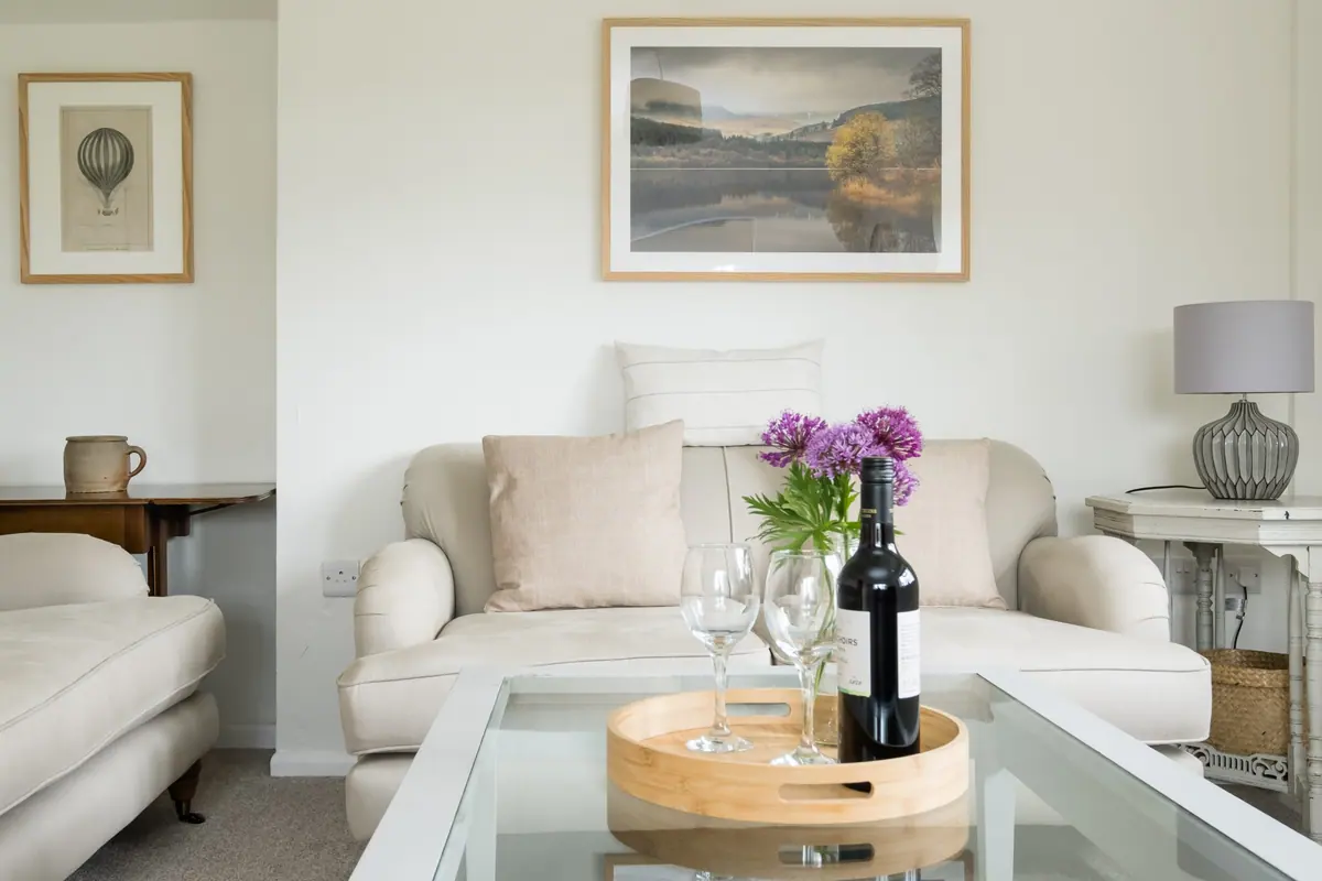 The annexe sitting room with a framed landscape print