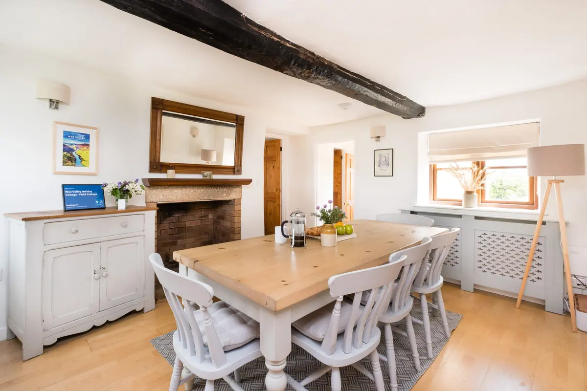 The dining room table set under an exposed beam