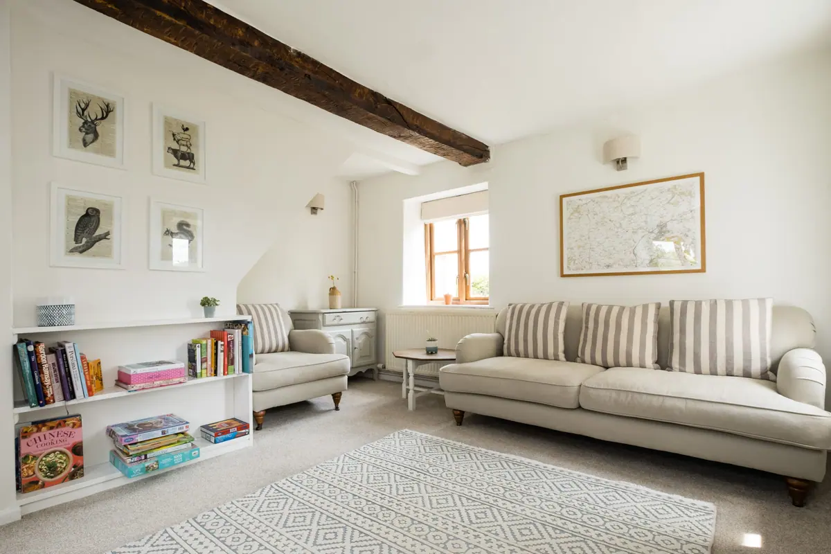 The beamed living room with sofa and bookshelves