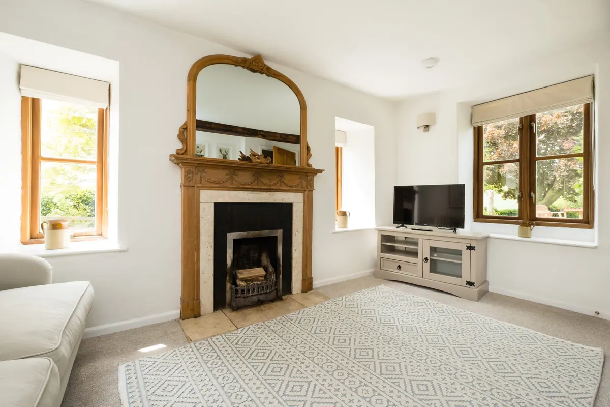 The living room fireplace with its gilt overmantel mirror
