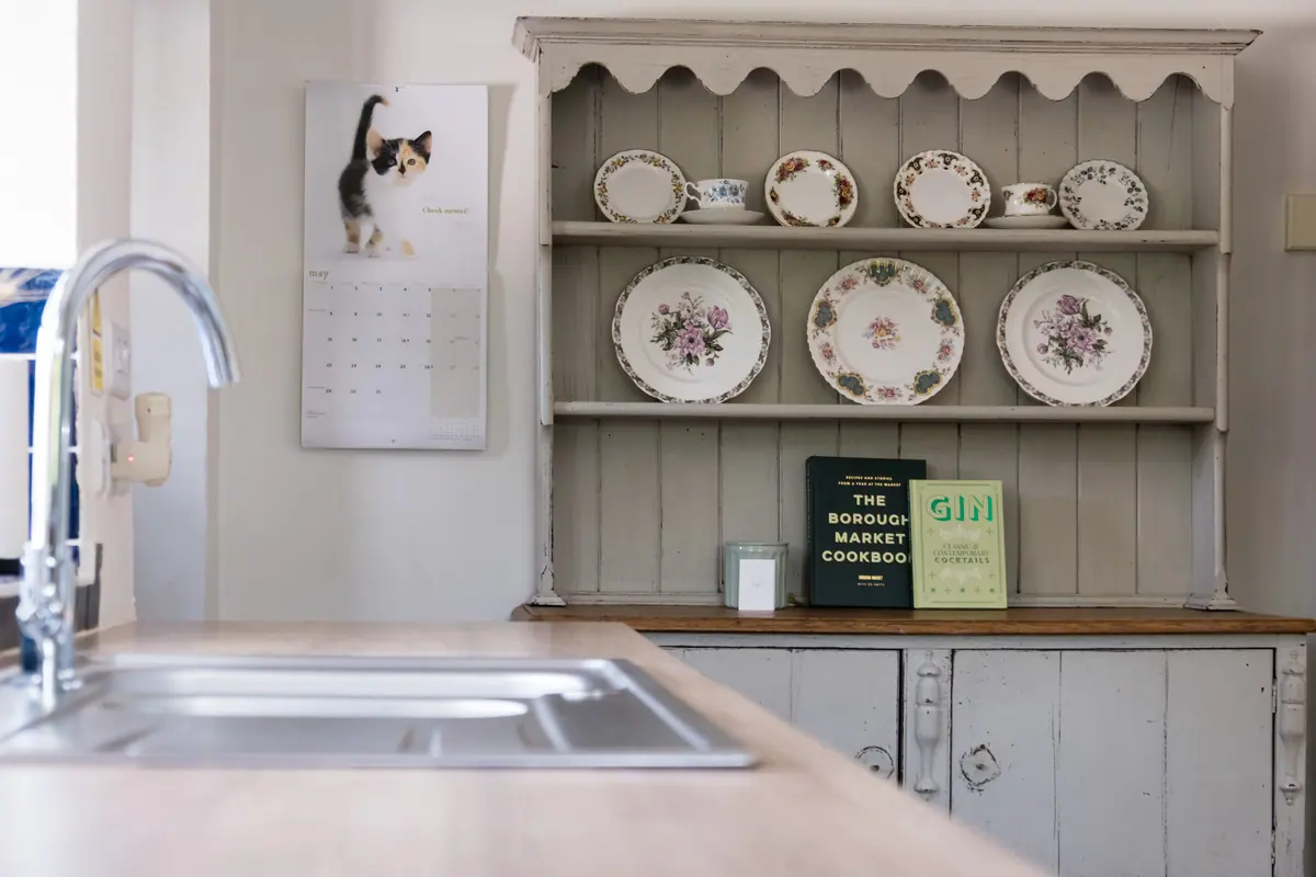 A painted dresser stacked with china