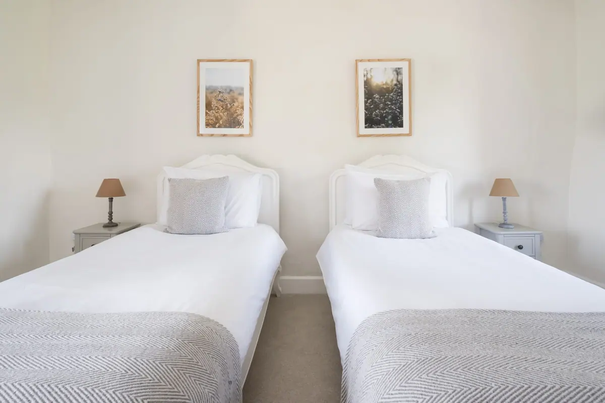 Two single beds with framed prints above