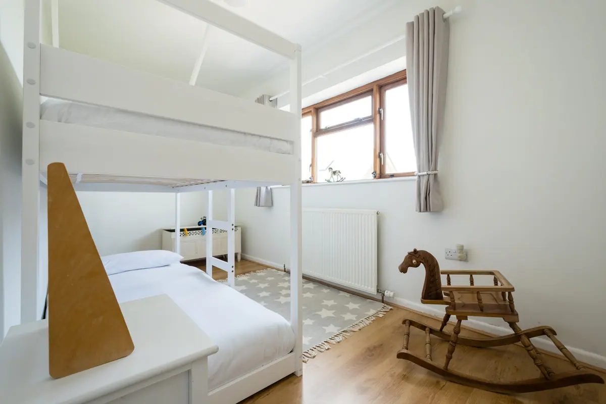 The bunk room with full-size bunks and a rocking horse