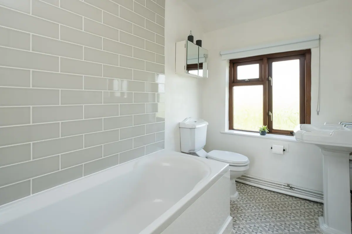 The upstairs bathroom with bath and metro tiling