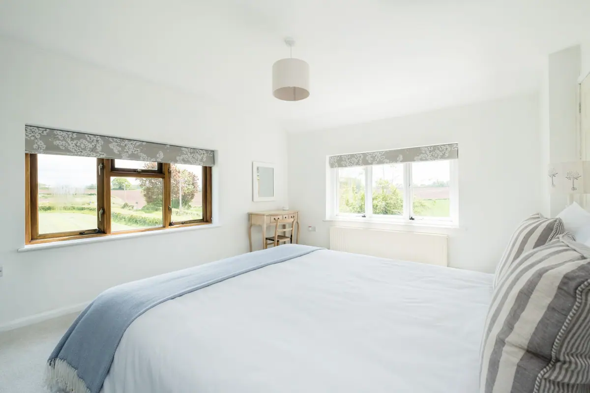 The bath beneath a window onto the fields