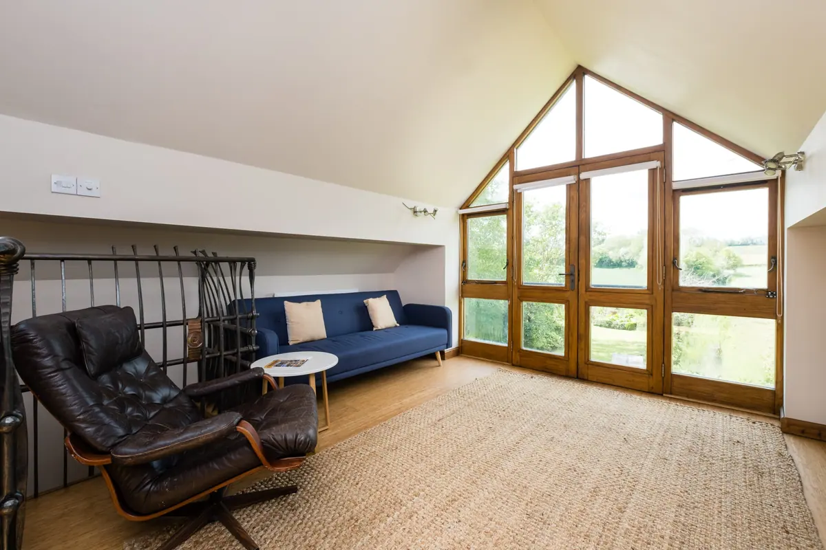 The annexe sitting room under its full-height gable window
