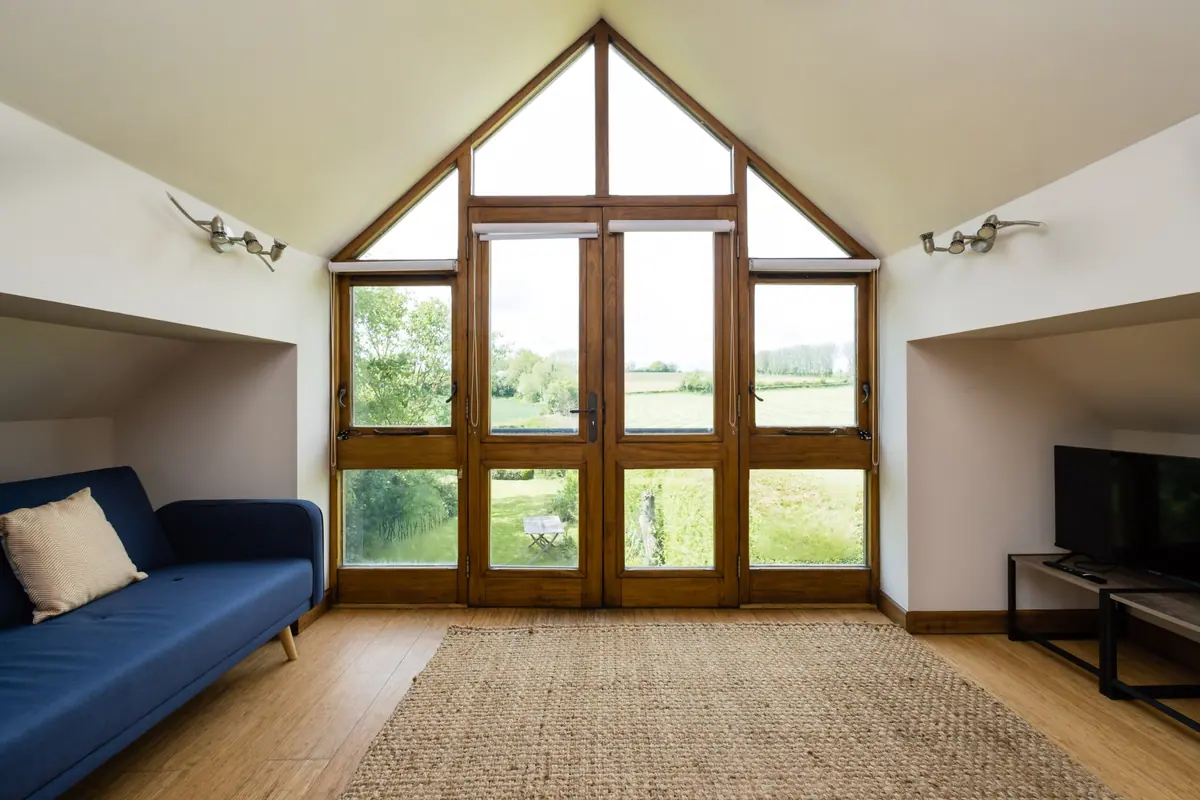 The gable window of the annexe looking over open fields